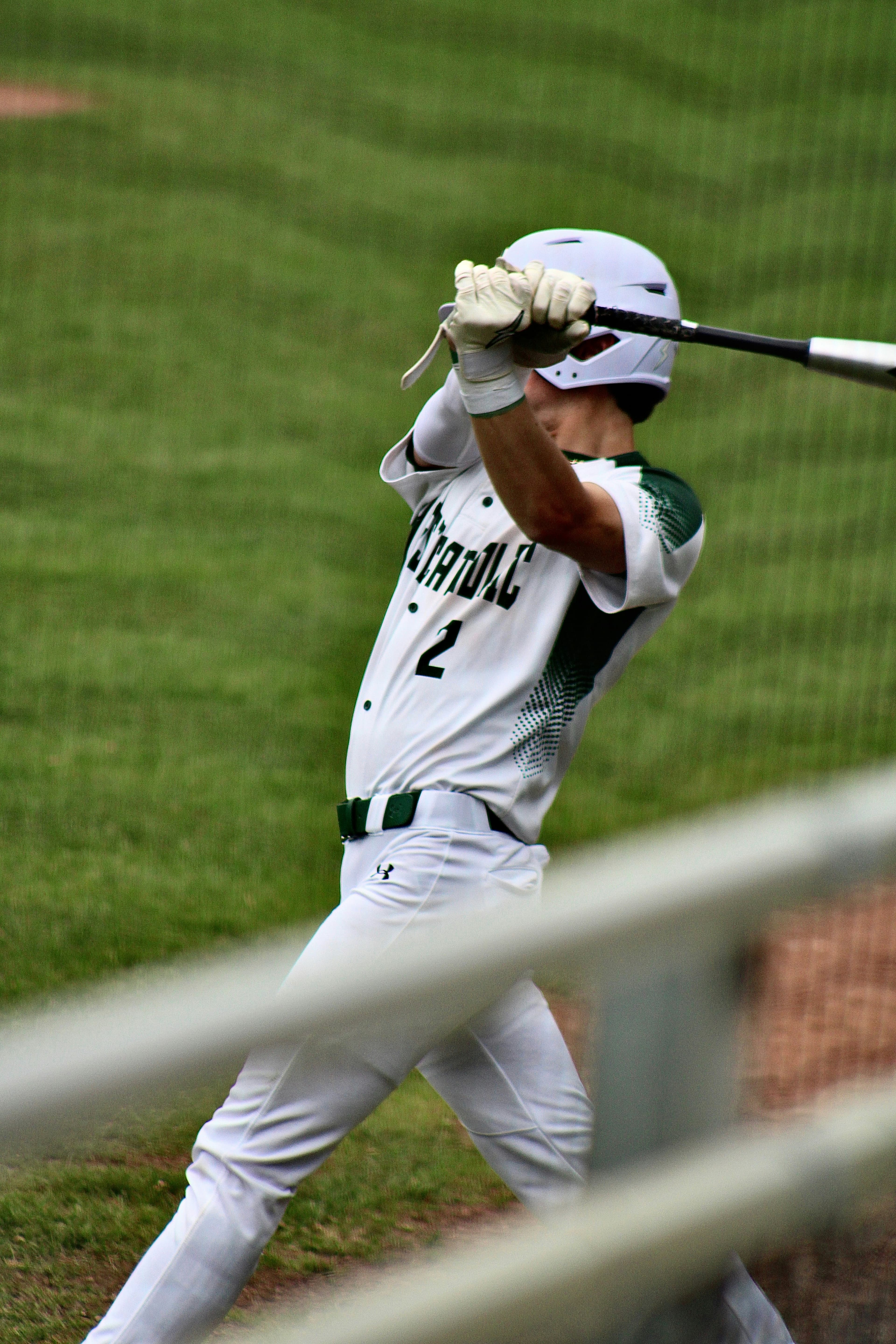 A youth baseball player swinging at a pitch